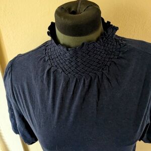 Moc turtleneck cotton knit stretch top with pleated shoulders.